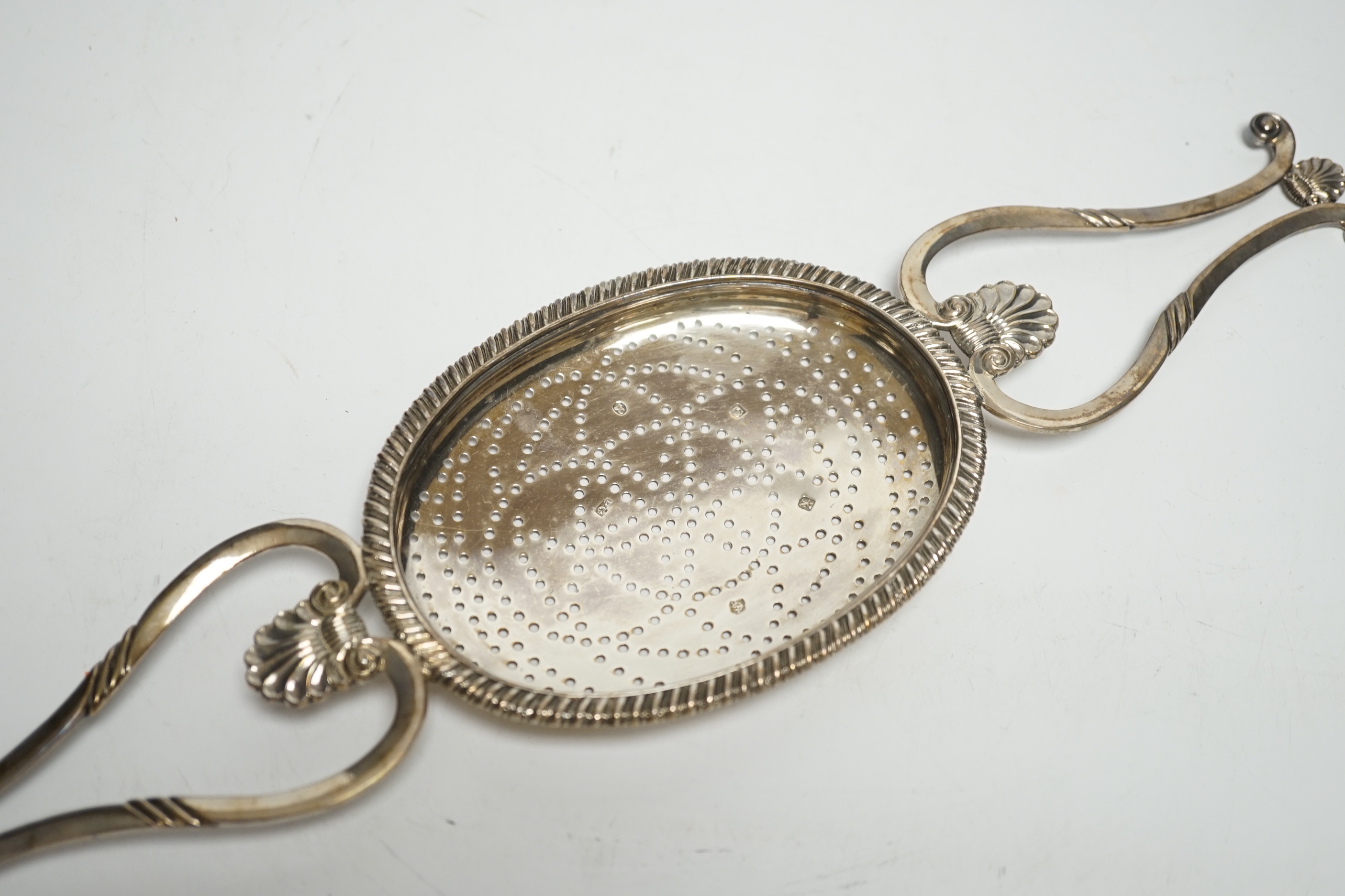 A George IV Scottish silver lemon strainer, Philip Grierson, Glasgow, 1821, 33.3cm, 167 grams